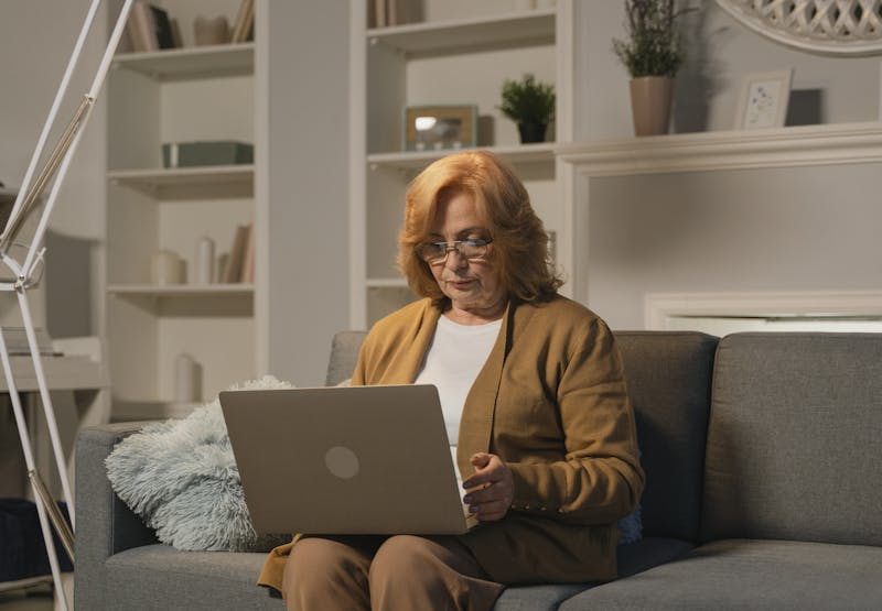 Senior woman working on a laptop in a cozy home setting